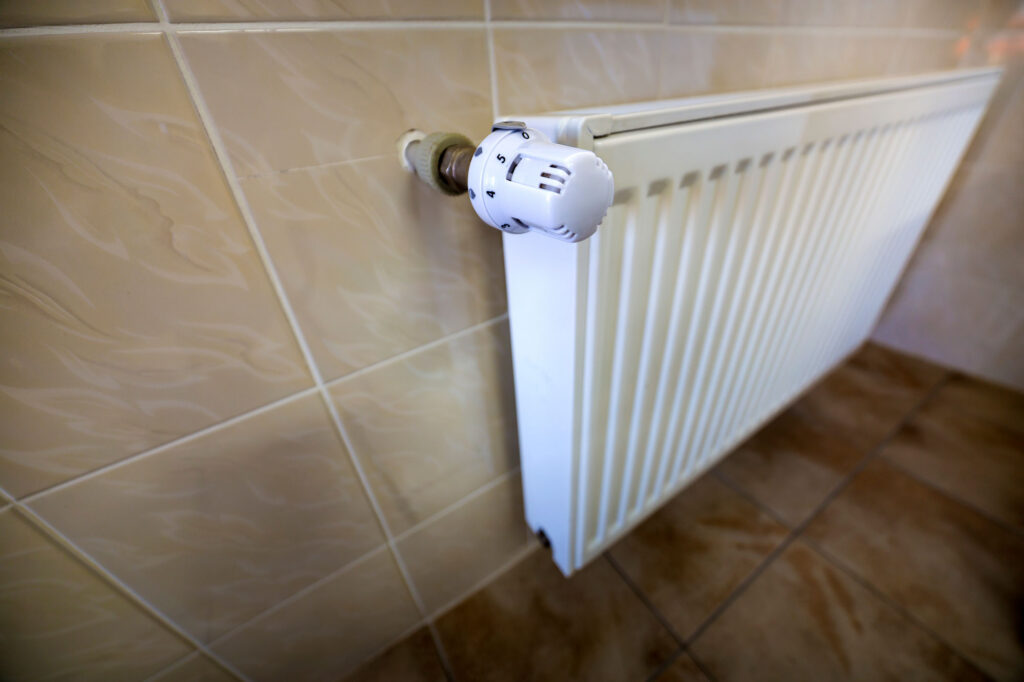 close-up-of-white-heating-radiator-with-thermostat-2024-12-06-18-06-48-utc